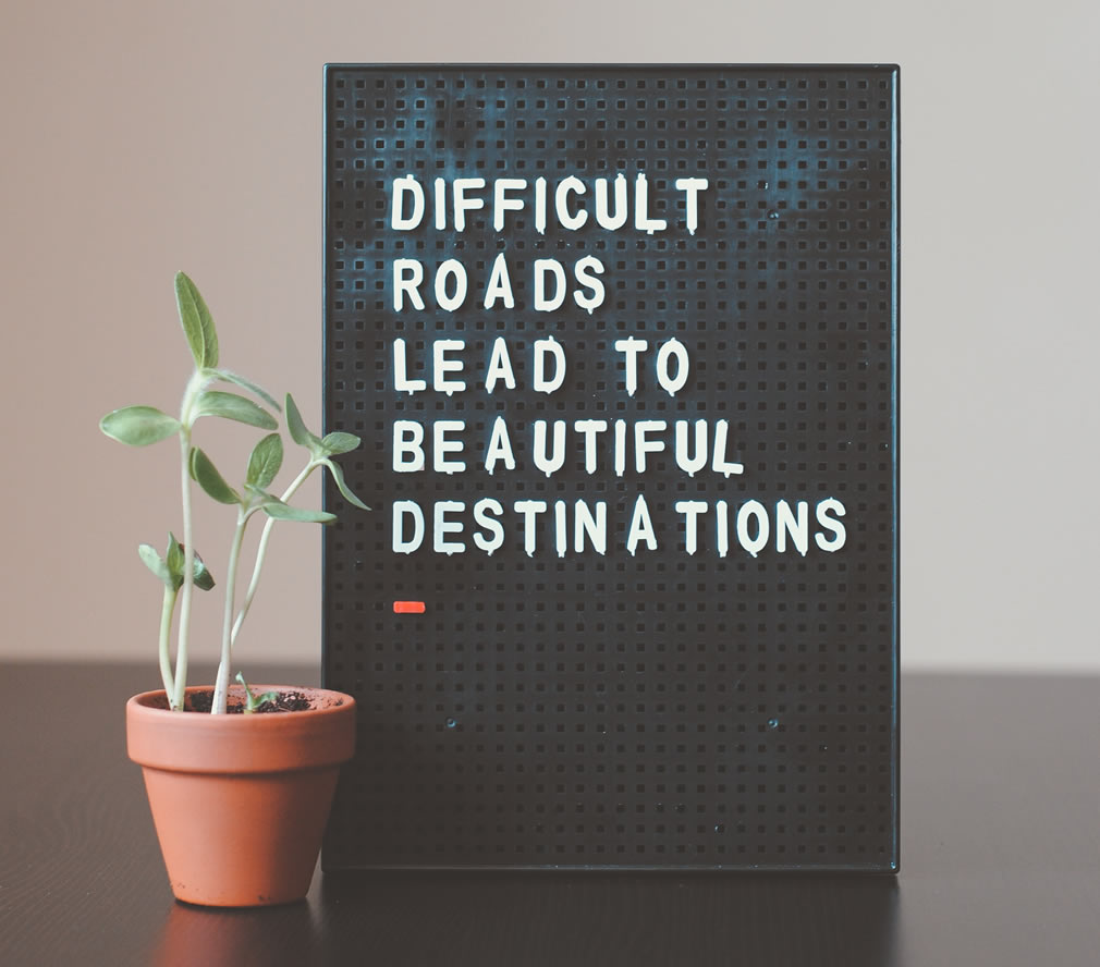 Photo of a sign that says Difficult roads lead to beautiful destinations.